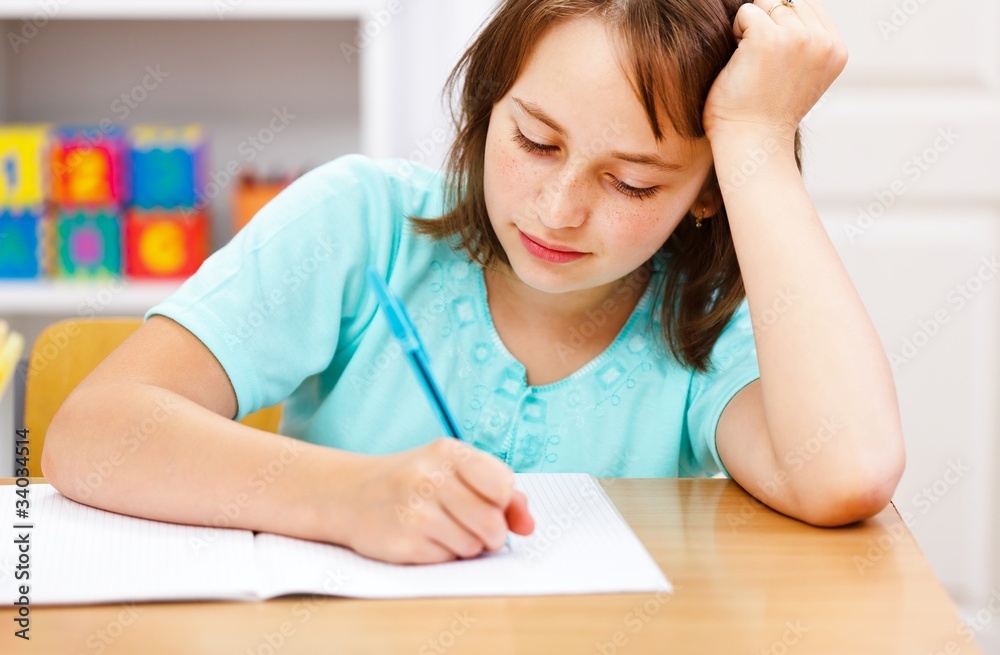 Schoolgirl writing boring homework Schoolgirl writing boring homework