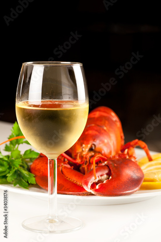 Glass of white wine with cooked lobster