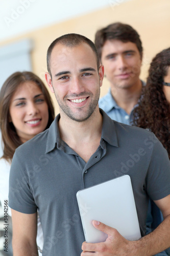 Fotografie Portrait of student standing with workgroup