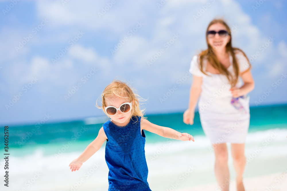 Mother and daughter running at beach Mother and daughter running at beach