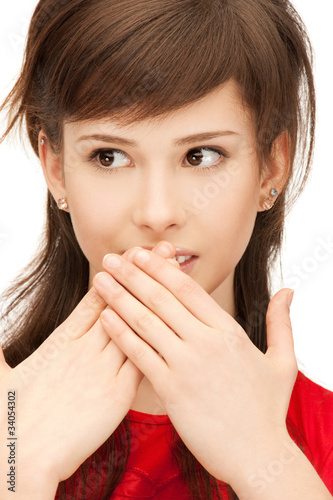 teenage girl with palms over mouth