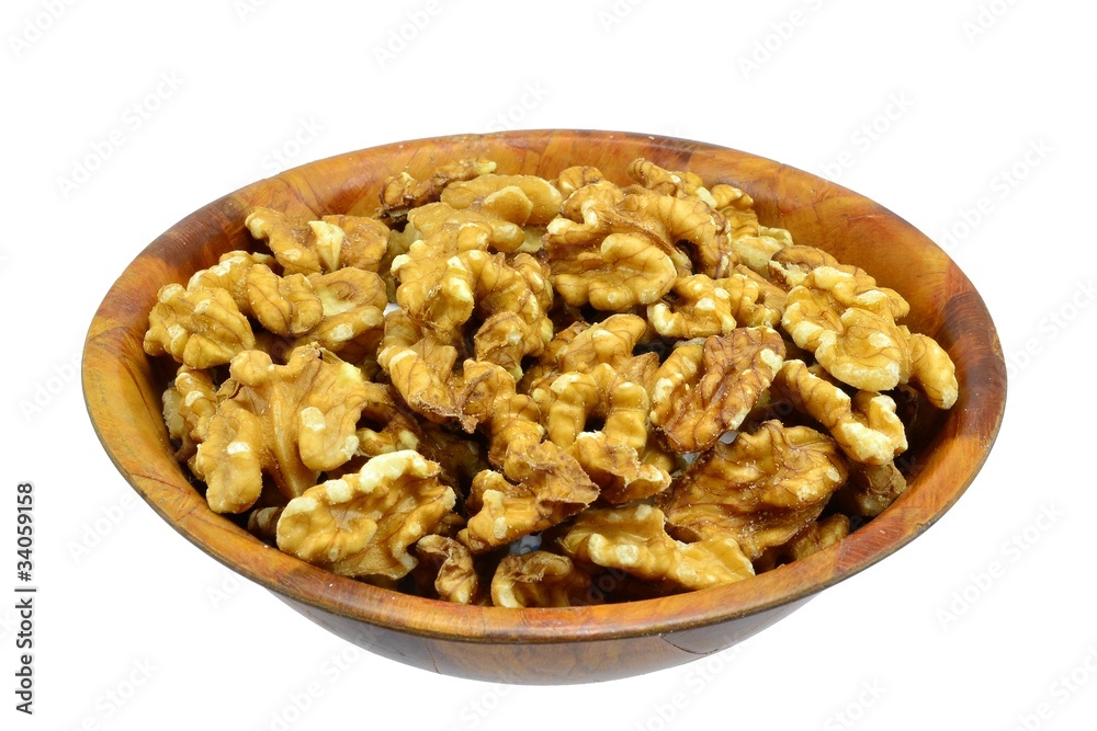 Walnuts in a wooden bowl on white background Walnuts in a wooden bowl on white background