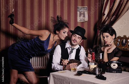 Gambling mafia type with cigarette, playing poker.
