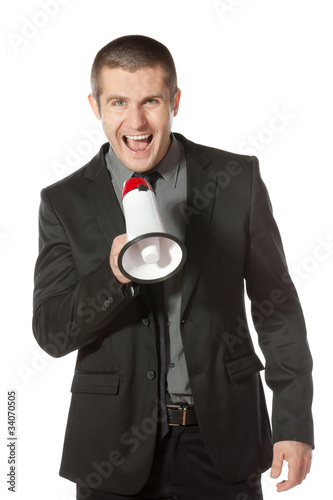 Fotografie Portrait of a young business man yelling into a megaphone.