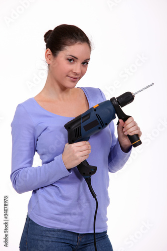 girl posing with drill