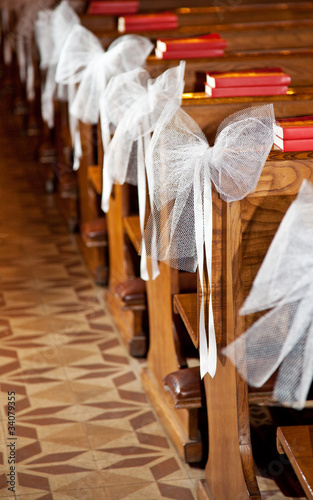 White bows in Catholic Church. photo