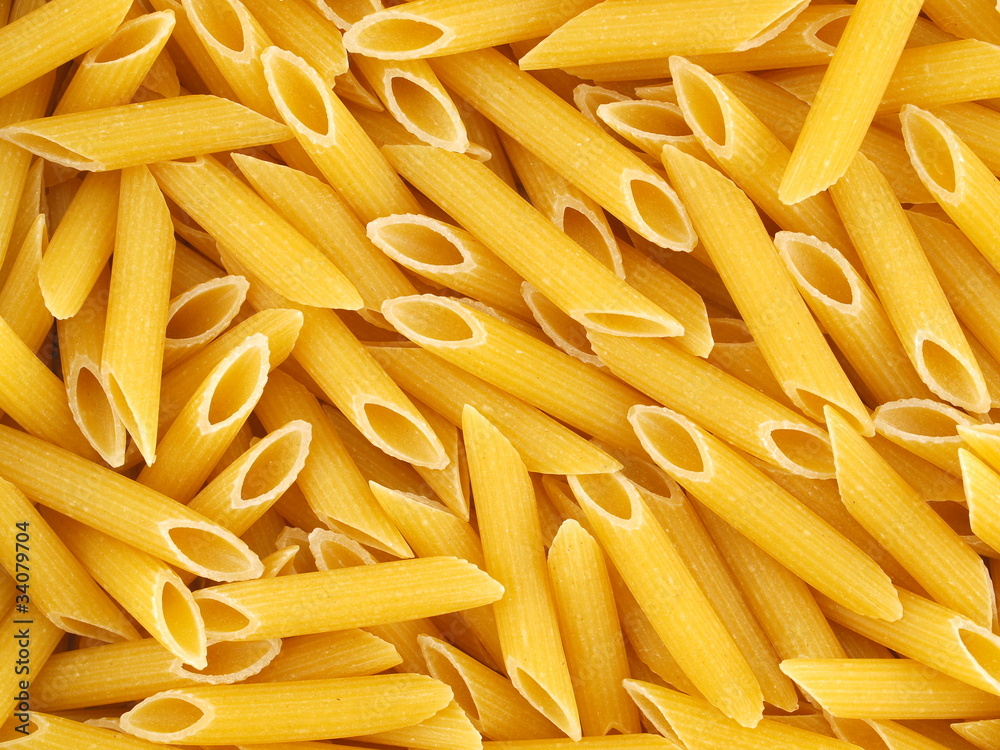 Closeup Background of Uncooked Italian Penne Pasta Closeup Background of Uncooked Italian Penne Pasta