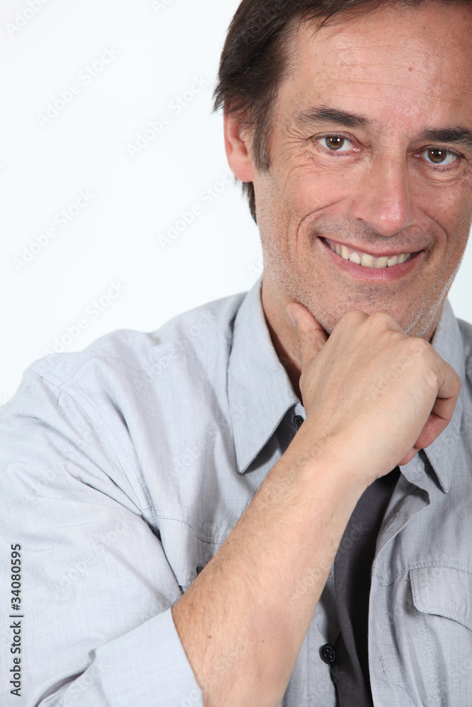 Man smiling holding chin. Man smiling holding chin.