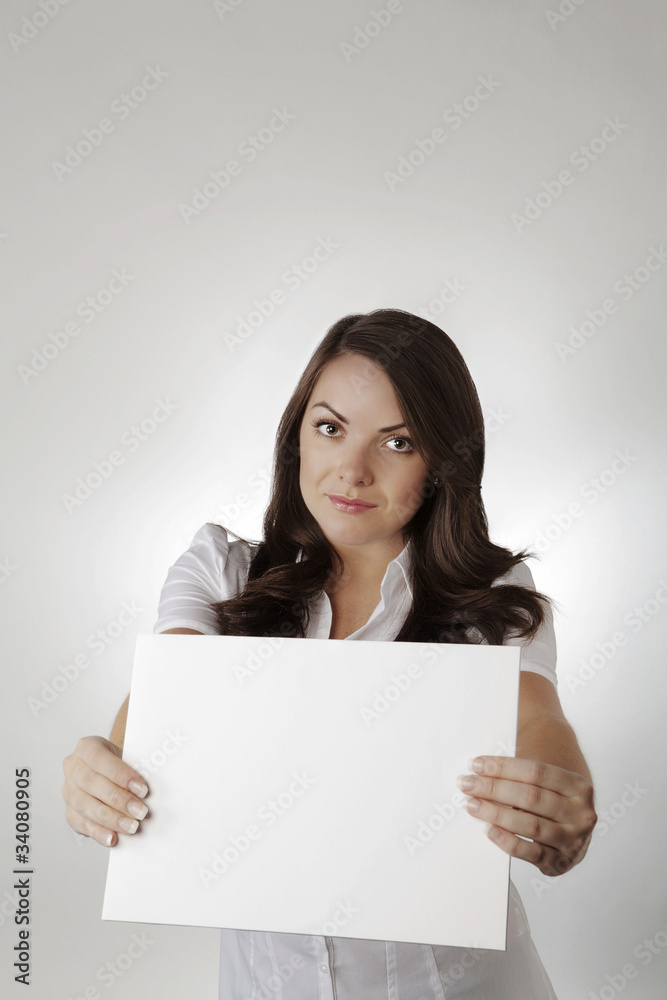 young woman holding up white card young woman holding up white card