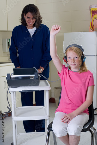 School nurse giving hearing test
