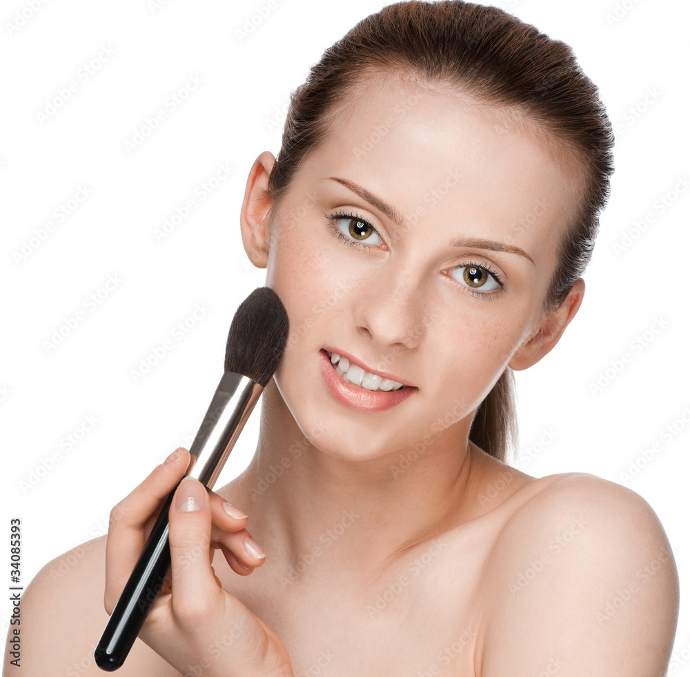 Beautiful young adult woman applying cosmetic brush Beautiful young adult woman applying cosmetic brush