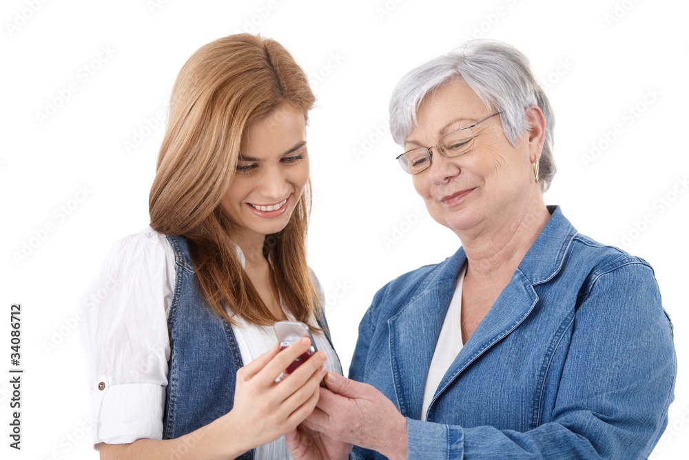 Mother and daughter looking at photos on mobile Mother and daughter looking at photos on mobile