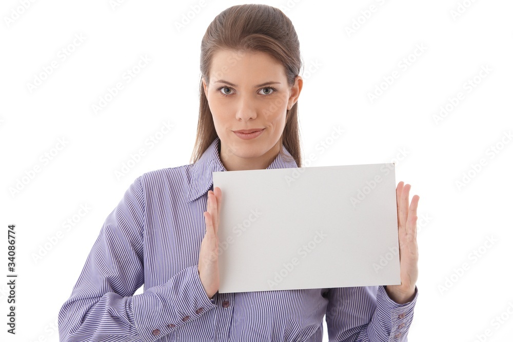 Confident woman holding blank sheet in studio Confident woman holding blank sheet in studio