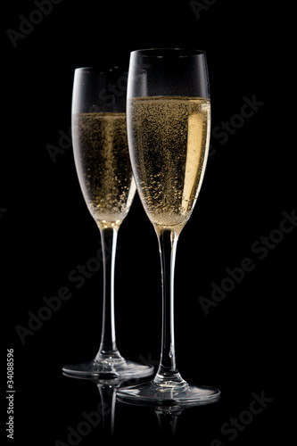 A glass of champagne, isolated on a black  background.