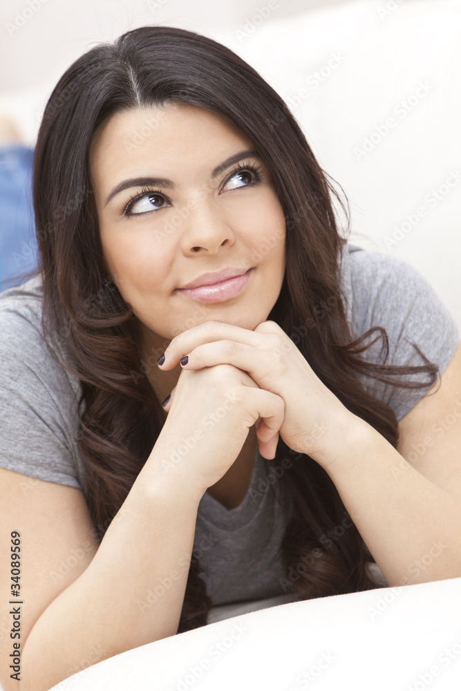 Beautiful Hispanic Woman Laying on Sofa Relaxing & Smiling Beautiful Hispanic Woman Laying on Sofa Relaxing & Smiling