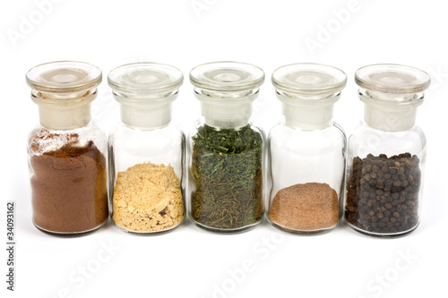 colorful spices in glasses with white background
