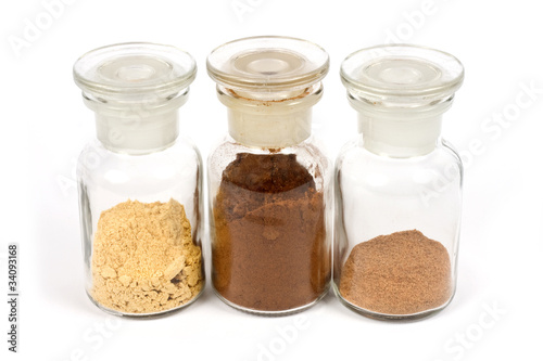 colorful spices in glasses with white background