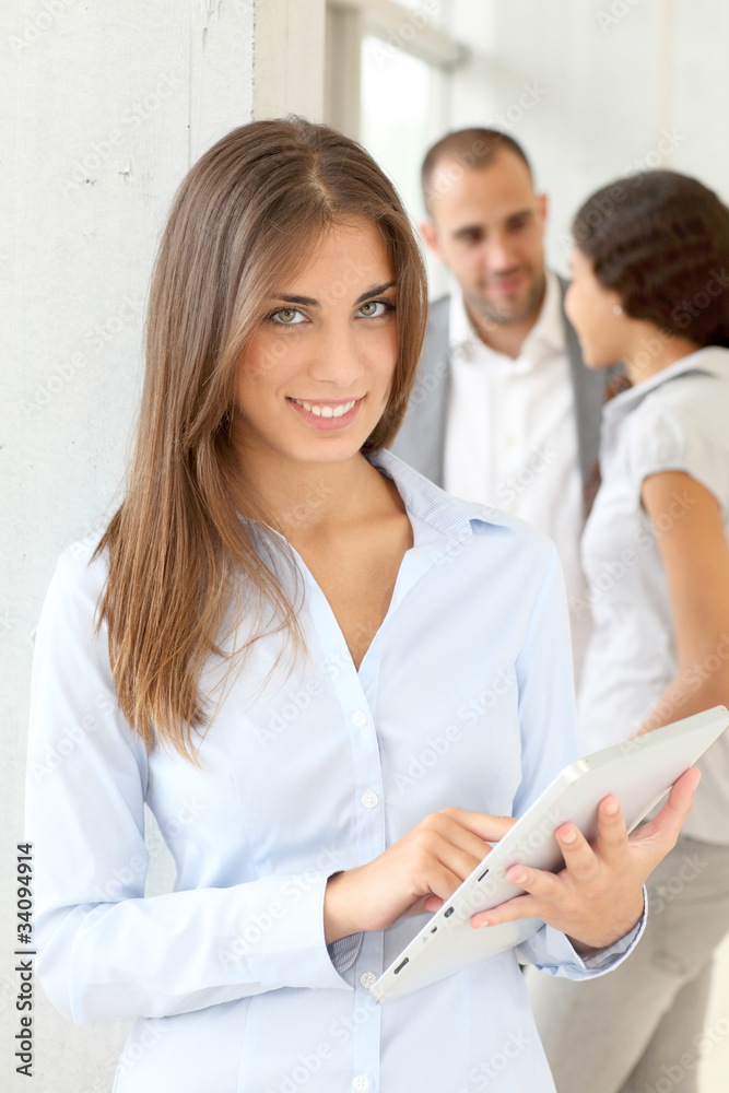 Fototapeta premium Young woman using electronic tablet in meeting
