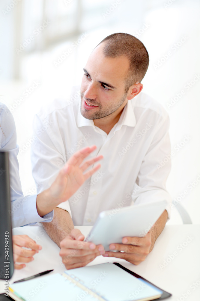 Fototapeta premium Young adults in training course using touchpad