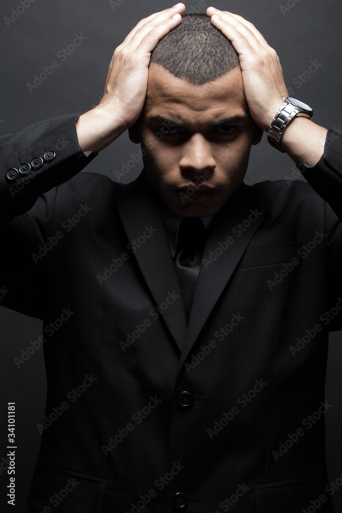Obraz premium Young African-American business man in black suit.