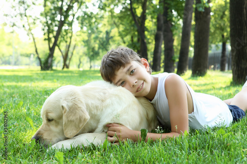 Little boy in the park with a dog