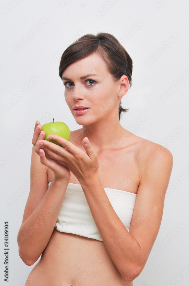 Beautiful woman holding green apple in hands Beautiful woman holding green apple in hands