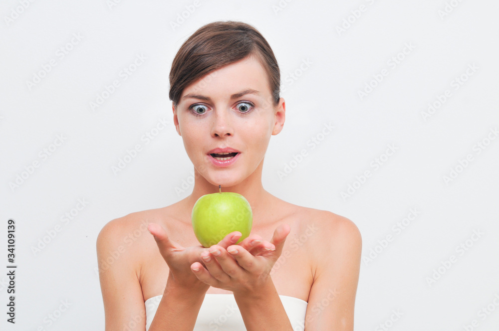Beautiful woman holding green apple in hand Beautiful woman holding green apple in hand