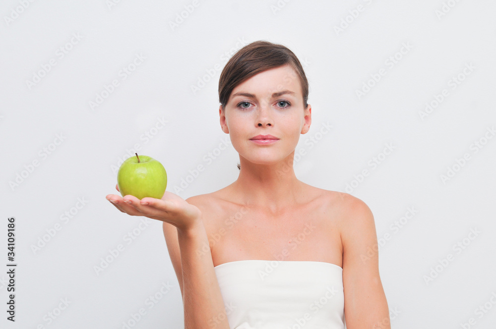 Beautiful woman holding green apple in hand Beautiful woman holding green apple in hand