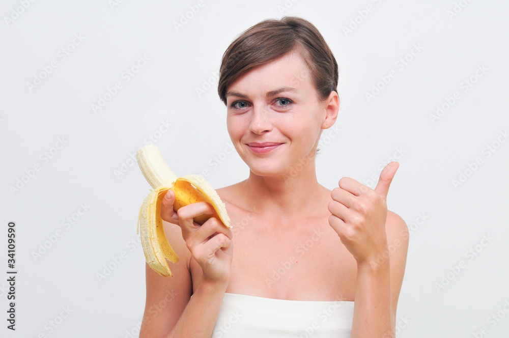 beautiful woman in white with banana in hand. beautiful woman in white with banana in hand.