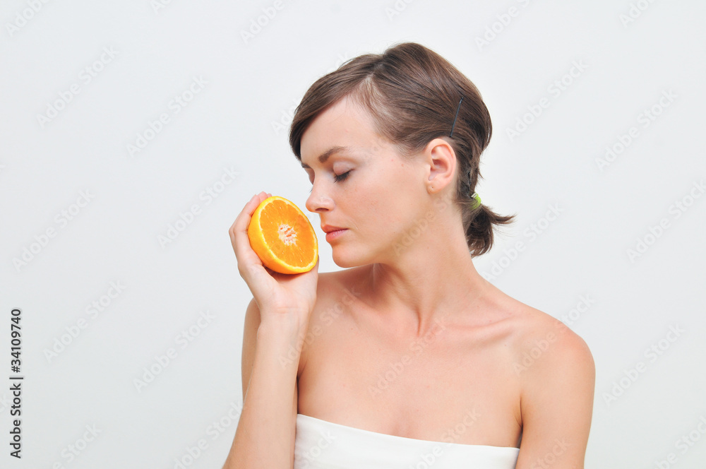 Beautiful woman holding orange in hands Beautiful woman holding orange in hands