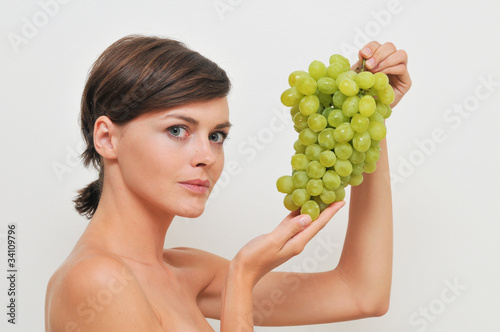 Young girl with green grapes.