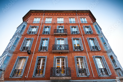 elegant old building, red bricks with wrought iron balconies