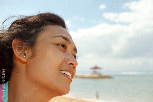 happy ethnic young woman on the beach