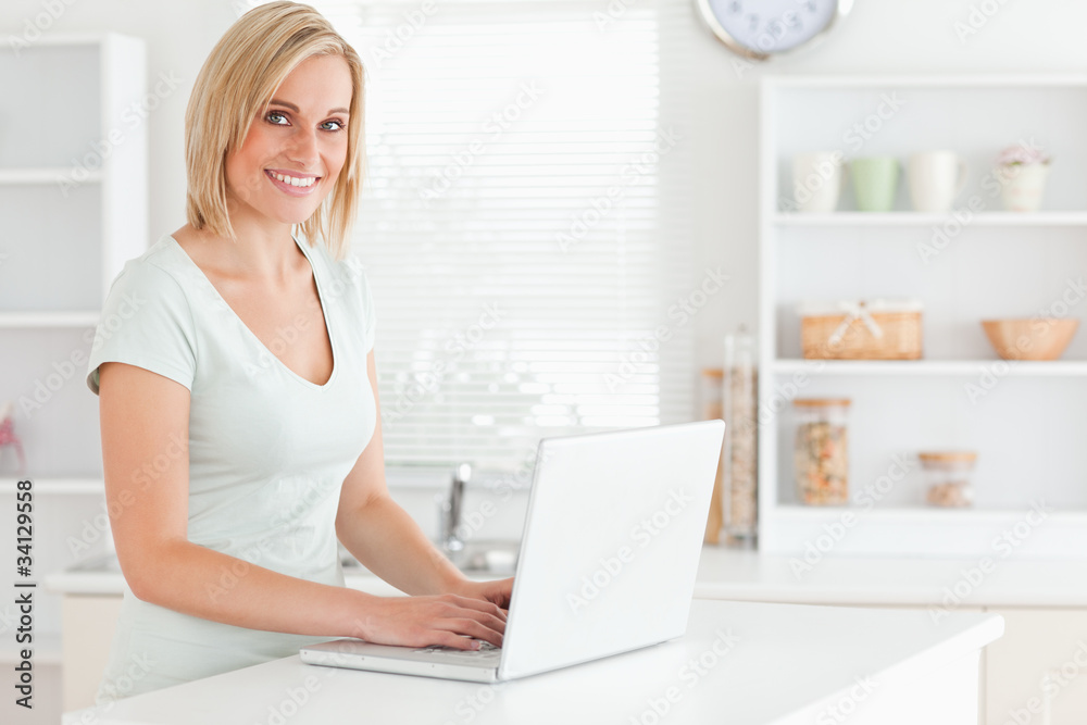 Charming woman with a laptop looking into the camera