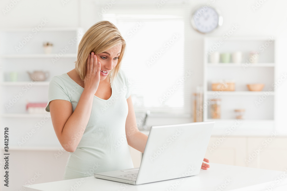 Amazed woman looking at notebook Amazed woman looking at notebook