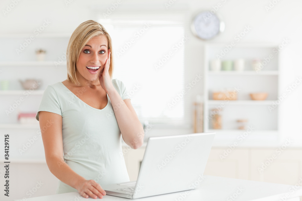 Amazed woman looking at notebook looks into the camera Amazed woman looking at notebook looks into the camera