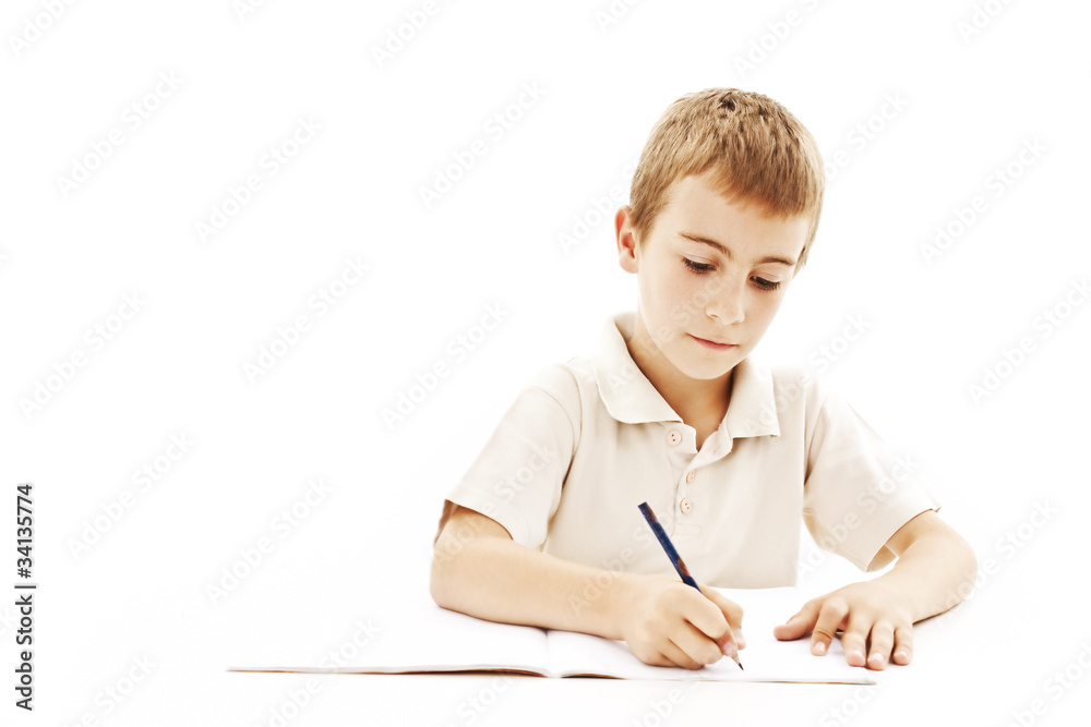School boy sitting and writing in notebook. Isolated on white School boy sitting and writing in notebook. Isolated on white