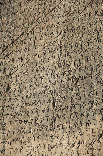 writing on the stone wall of the ancient city of Turkey Patara