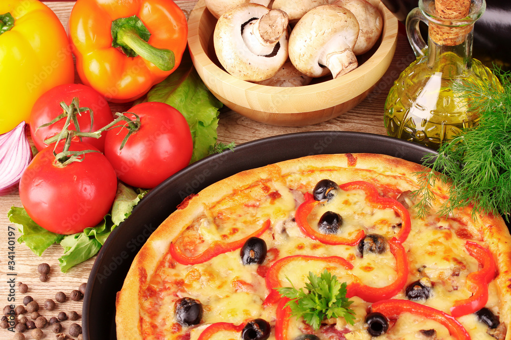 tasty pizza with olives and vegetables on a wooden background tasty pizza with olives and vegetables on a wooden background