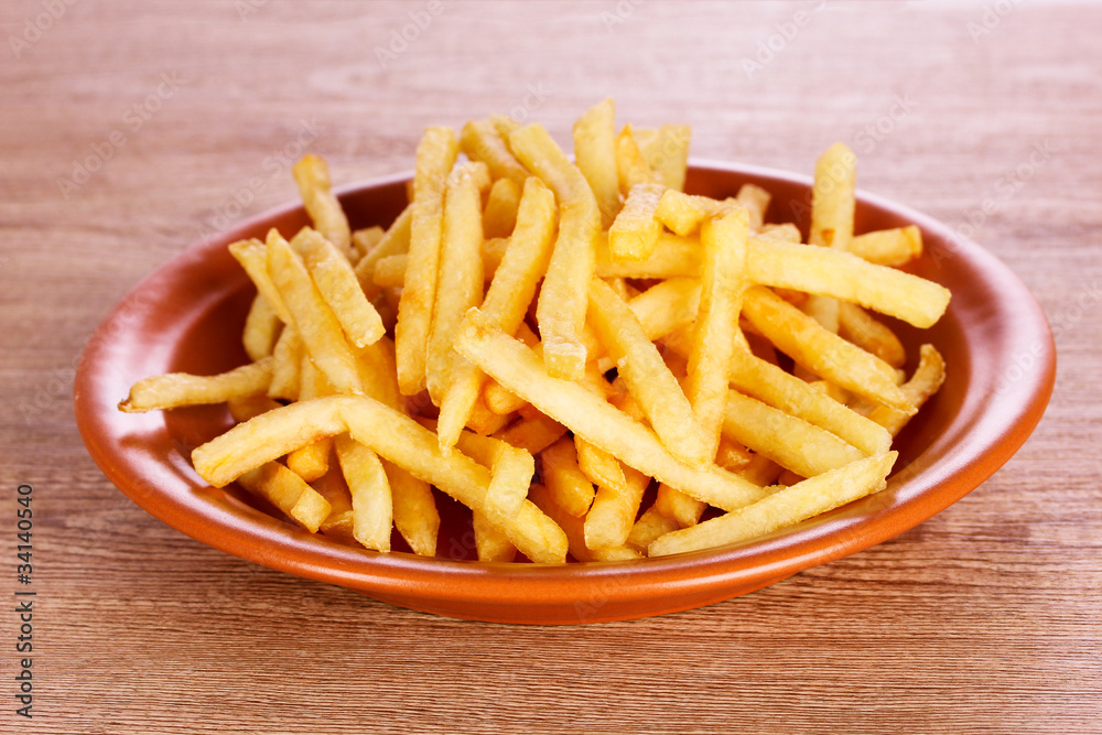 French fries on wooden background French fries on wooden background
