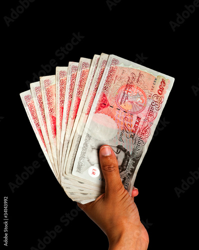 Money held in hand - UK Currency with clipping path - Black BG