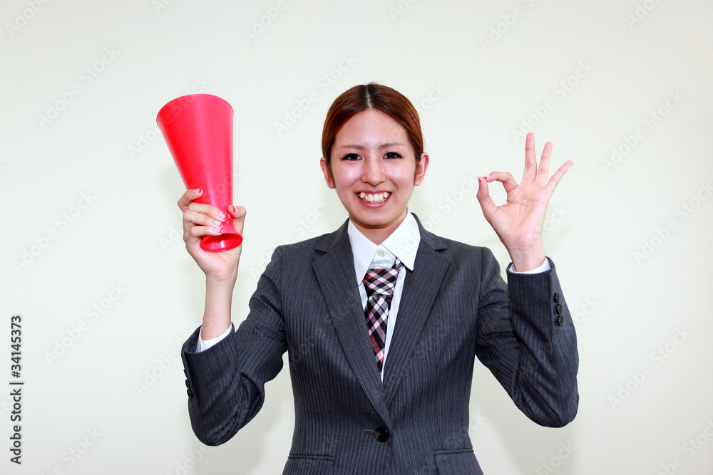 メガホンを持ちOKサインを出すオフィスレディー