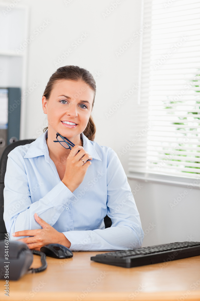 Thinking businesswoman behind her desk Thinking businesswoman behind her desk