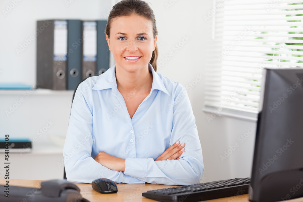 Beautiful businesswoman sitting behind her desk Beautiful businesswoman sitting behind her desk