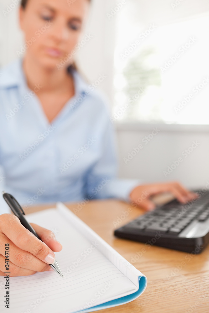 Beautiful working businesswoman sitting behind her desk
