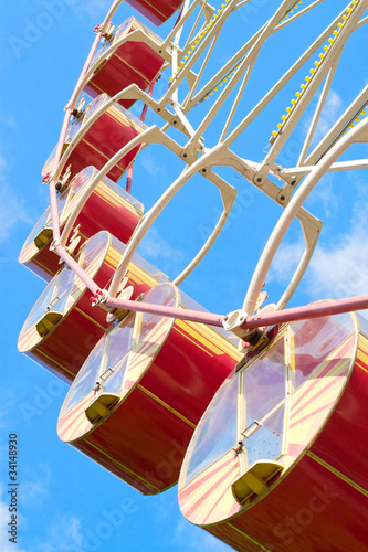 Ferris wheel carousel against blue sky