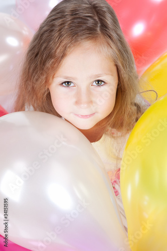 Little girl with balloons in studio