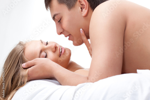 couple lying on white bed
