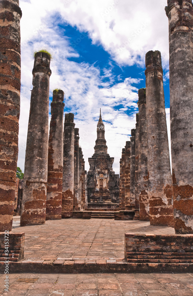 Ruin pillars and pagoda in back in sukhothai