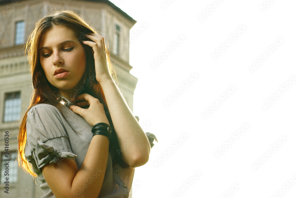 Portrait of a beautiful woman posing at the city street